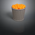 Grey Woven Basket Filled With Round Orange Decorative Balls On Dark Surface