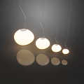 Modern Spherical Pendant Lights In Various Sizes With Warm Light And Floor Reflections