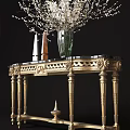 Elegant Gold Carved Console Table With Black Marble Top Green Vase And White Floral Arrangement