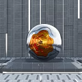 Silver Spherical Metallic Sculpture With Orange Red Textured Surface On Black Pedestal Against Gray Wall