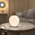 Round White Decorative Lamp On Marble Coffee Table In Minimalist Living Room With Gray Sofa