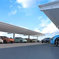 Various Colored Cars in Parking Lot under White Canopies with Blue Sky and White Clouds