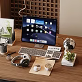 Tablet with Keyboard Mouse and Headphones on Wooden Desk with Globe Potted Plant and Stationery