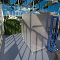 Industrial Factory Building with Glass Facade in Green Outdoor Area Under Blue Sky and Clouds