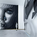 Modern 3D Abstract Face Relief Background Wall In Art Gallery With Standing Woman Figure