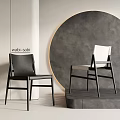 Wabi Sabi Dining Chairs Black And White Modern Minimalist Design Against Circular Gray Wall Backdrop