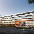 Modern School Building With Multi Story Structure Large Windows Glass Facade And Landscaped Entrance