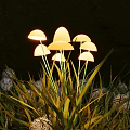 Mushroom Shaped Outdoor Lights Glowing Warmly Among Green Grass in Garden