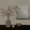 Vase with Dried Flowers on Wooden Tabletop with Stacked Bowls and Abstract Painting
