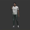 A Man Wearing White T-shirt And Green Graffiti Jeans Holding Phone Against Black Background