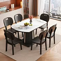 Modern Dining Room with Marble Tabletop Six Black Chairs Flower Vase and Bowl of Fruits
