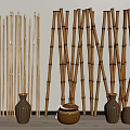 Bamboo Poles Standing With Woven Containers And Vases In Indoor Display Setting