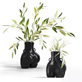 Unique Shaped Black Vases with Green Leaves Displayed on White Background 3d model