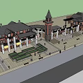 Red Brick Commercial Complex With Clock Tower And Multiple Storefront Buildings