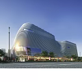 Modern Streamlined Public Building With Curved Metal Facade And Evening Pedestrian Area