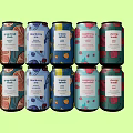 Colorful Beverage Cans Neatly Arranged On Green Background With Vibrant Designs
