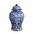 Blue And White Ceramic Vessel With Floral Tree Patterns Gold Trim And Blue Lid Design