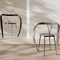 Modern Leisure Chairs With Curved Metal Frame And Minimalist Design In Light Room