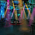 Modern Bar Interior With Neon Lights Bar Counter Tables Chairs And Futuristic Decor