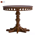 Traditional Round Wooden Dining Table With Intricate Carved Base And Decorative Details