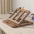 Wooden Laptop Stand On Light Desk With Green Mug Colored Pencils Figurines And Charging Phone