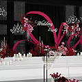Banquet Hall Decorated For Wedding Party With Pink Floral Decor Chandeliers And Petals
