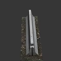 Concrete Curb With Surface Scratches Gravel And Grass At The Bottom