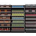 Display Shelves with Various Colored Bottles Neatly Arranged in Retail Store
