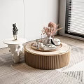 Round Ribbed Wooden Coffee Table With Pampas Grass Tea Set And Books On Geometric Rug
