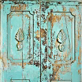 Vintage Blue Wooden Door With Distressed Paint And Carved Leaf Patterns