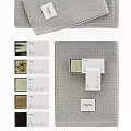 Grey Waffle Textured Towels Neatly Stacked With Decorative Gift Boxes