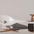 White Modern Lounge Chair With Curved Design And Hollow Cutout By Side Table