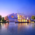 Modern Waterfront Hotel Building With Curved Exterior Illuminated By Lights And Surrounding Trees