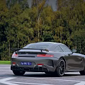 Gray Luxury Mercedes AMG GT Sports Car Parked On Road With Green Trees Background