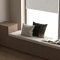 Modern Window Seat with White Black and Brown Pillows Open Book and Wooden Drawer Cabinet