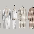 Various Colored Bathrobes and Towels Hanging on Wall Hooks with Soft Fabric