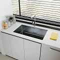 Modern Kitchen Sink With Chrome Faucet White Cabinets And Glass Jars On Countertop
