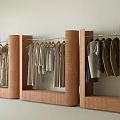 Modern Clothing Store with Stylish Clothing Racks Hanging Neutral Tones Apparel in Minimalist