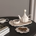 White Ceramic Tea Set With Teapot Cups Tray Cookies And Books On Black Round Table