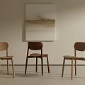 Minimalist Modern Dining Chairs in Light and Dark Wood Tones Against Light Wall with Abstract Painting