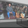 Man Sitting In Room With Guitars Records Speakers Headphones And Audio Gear