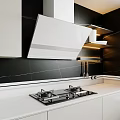 Modern Kitchen Appliances With White Range Hood Black Gas Stove And Warm Lighting