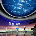 Modern Exhibition Space with White Geometric Walls Display Stand Screens Globe and Blue Lighting