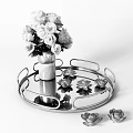 White Flowers In Ceramic Vase On Round Gold Glass Tray With Red Lotus Decorations