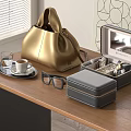 Golden Leather Bag And Gray Jewelry Storage Box On Wooden Table With Coffee Cup