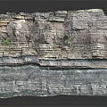Outdoor Garden Landscape Featuring Natural Stratified Rock Layers And Small Green Plants