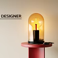 Designer Candle Lamp With Transparent Glass Shade And Warm Yellow Light On Red Base