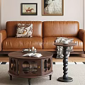 Round Wooden Coffee Table With Open Book Tray And Small Side Table By Leather Sofa