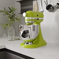 Green Stand Mixer on White Kitchen Countertop with Potted Plant and Glass Vase
