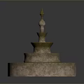 Ornamental Multi Tiered Stone Fountain Featuring Textured Base And Decorative Spire